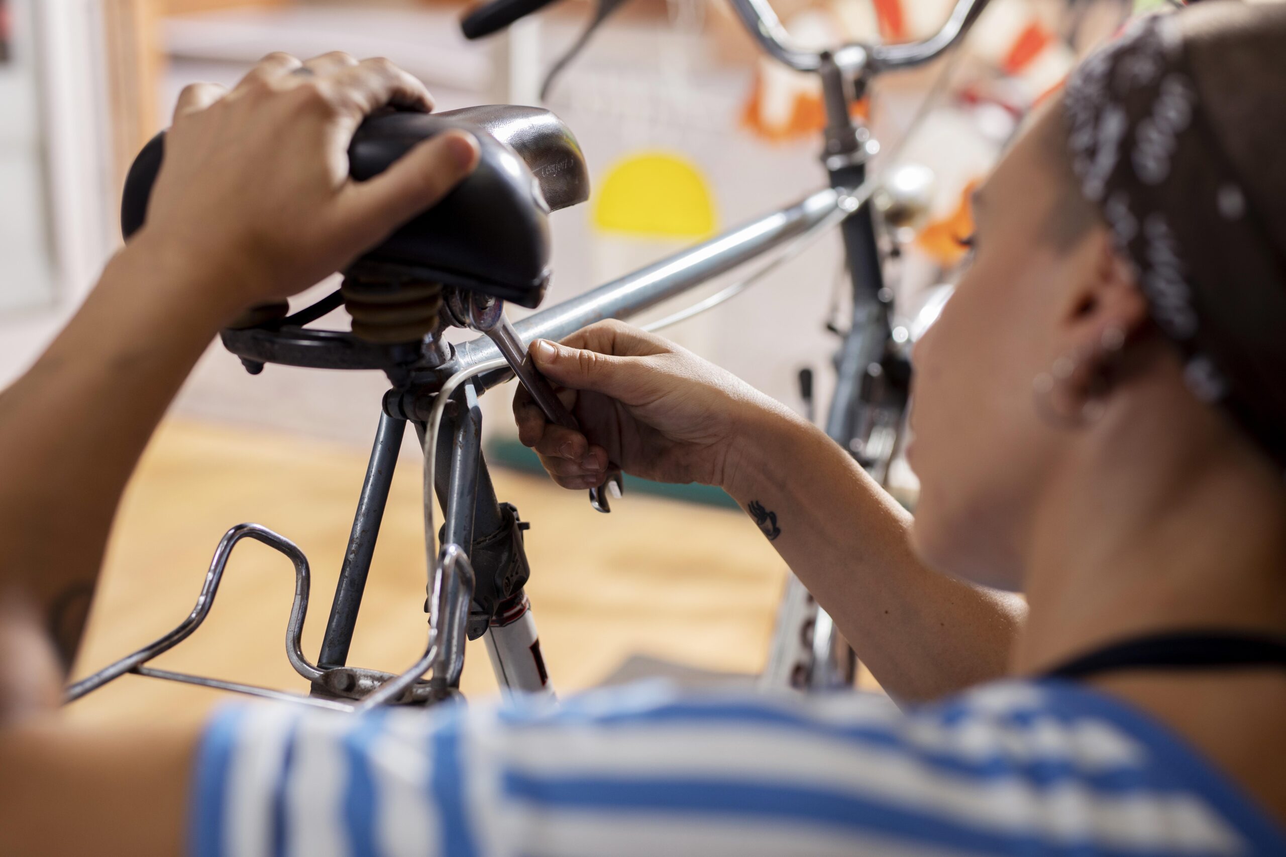 close-up-worker-repairing-bicycle