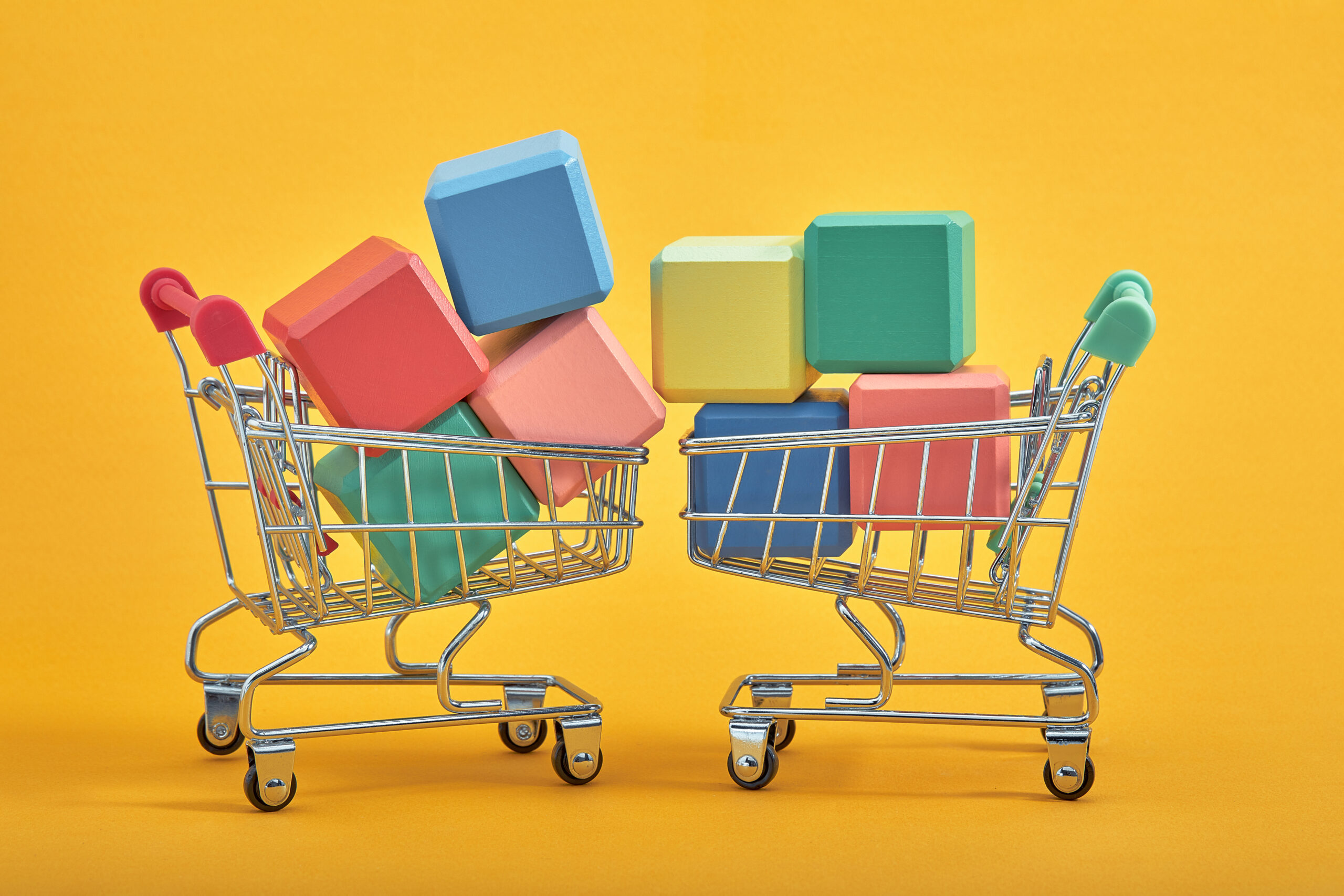 empty wooden cubes mockup style, copy space with shopping trolleys on yellow background. Colourful blocks template for creative design, place for text
