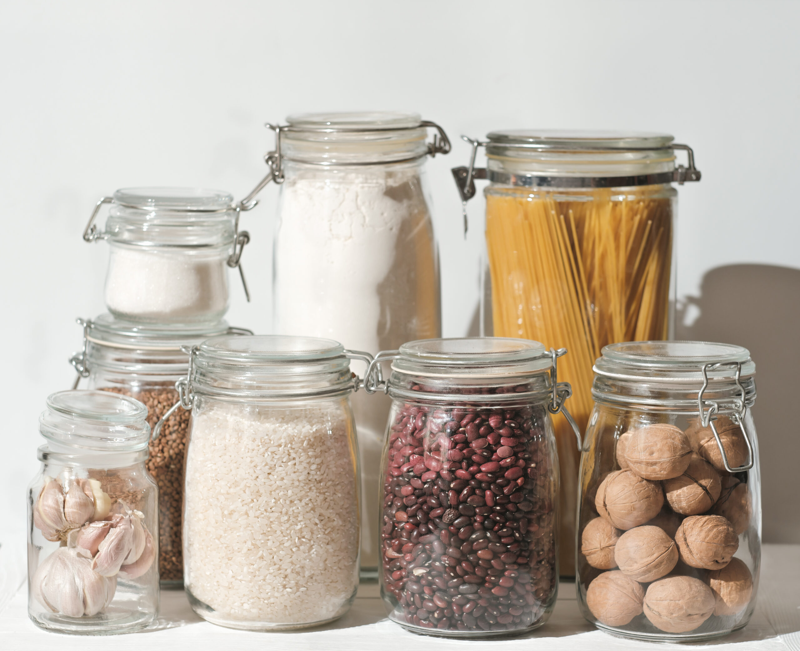 Organic products in a zero waste jars. Food storage in a low-waste kitchen. beans and nuts in glass jars on the table. Eco-friendly grocery shopping without plastic.